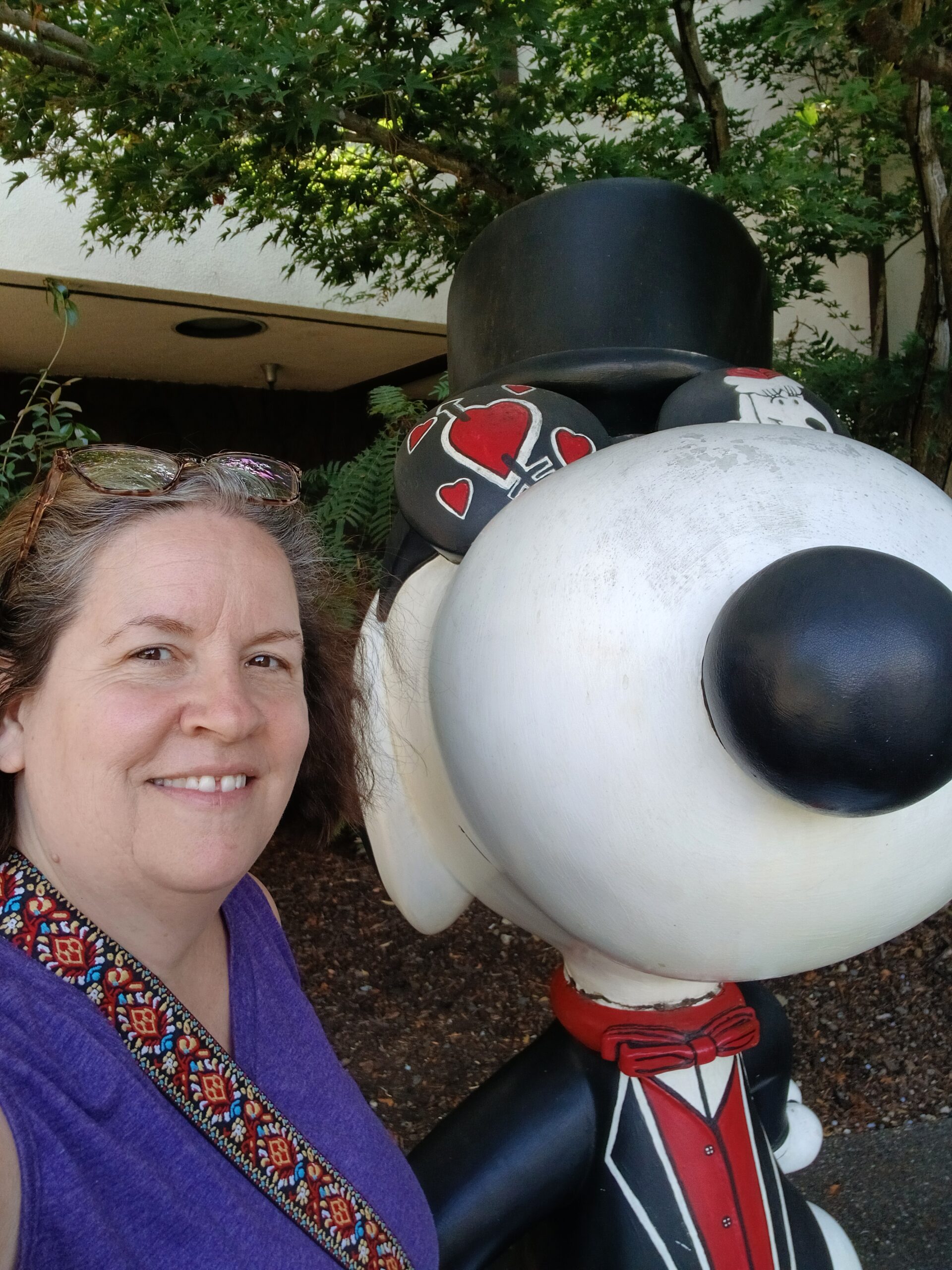 Picture of Terri next to a Snoopy sculpture outside of the Charles M. Schulz Museum in Santa Rosa, California
