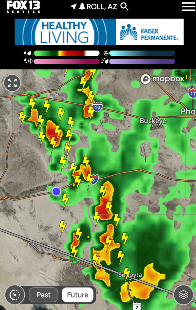 Screenshot of Q13 Weather App weather over Roll, Arizona showing rain and lightning.
